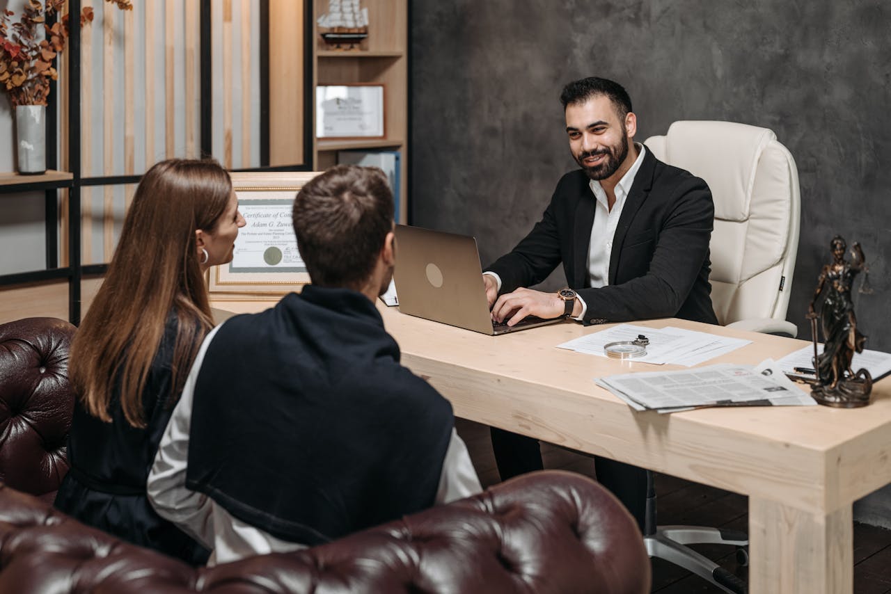 services-01 A professional meeting with a lawyer consulting clients in an upscale office environment.