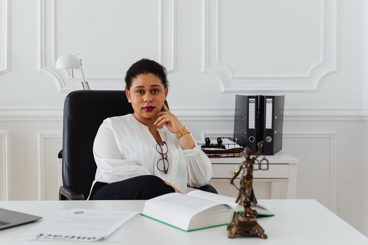 services-02 Portrait of a professional lawyer sitting confidently in a modern office, conveying authority.