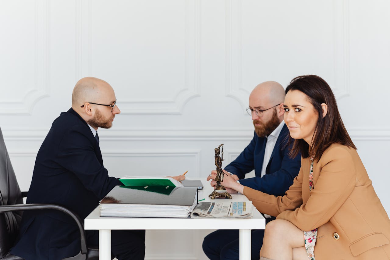 services-03 A lawyer consulting a couple in an elegant office setting, focusing on legal matters.